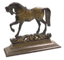 A Victorian brass doorstop, cast as a prancing horse, on a foliate scroll ground, above an outswept
