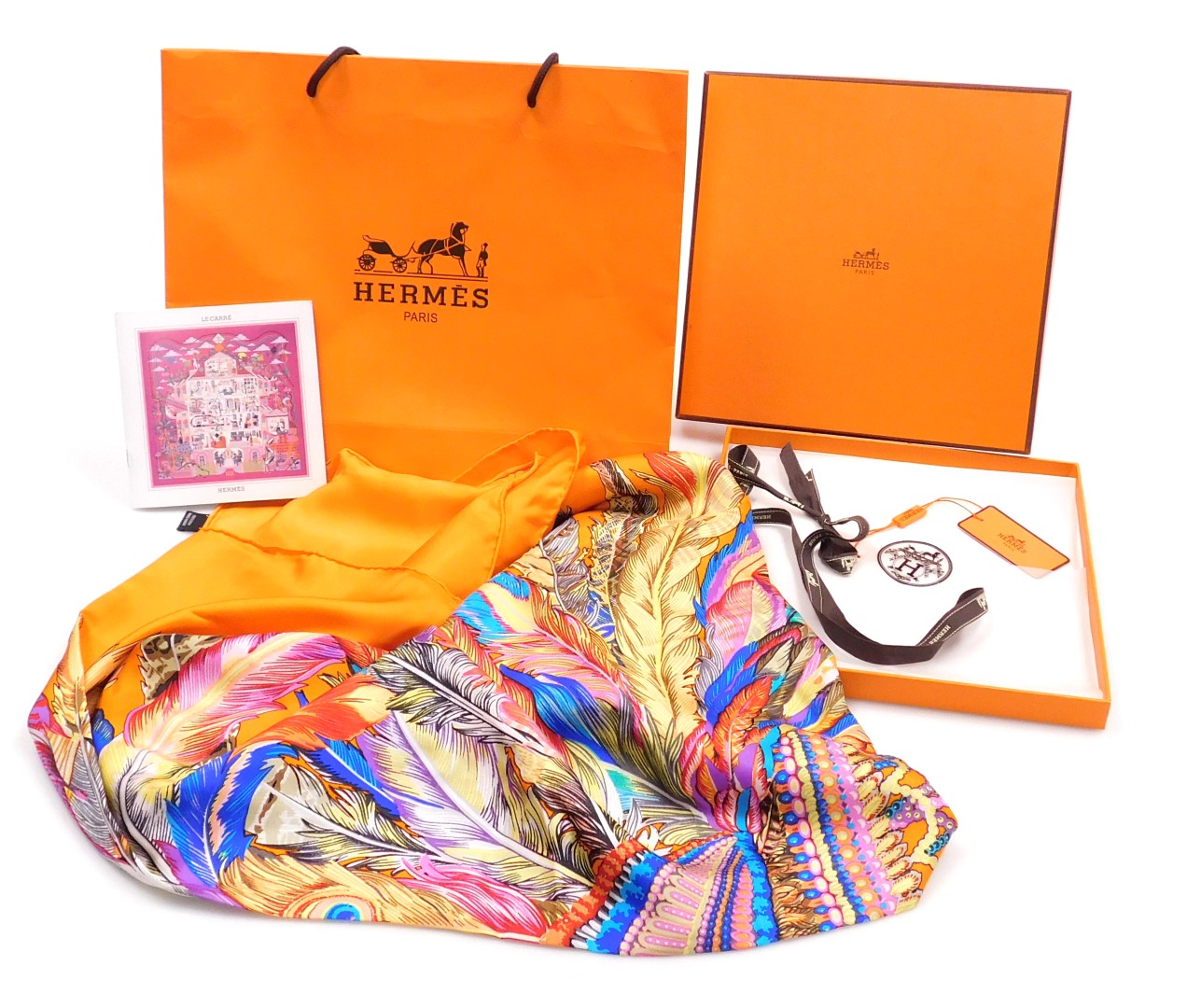 A Hermes orange silk scarf, decorated with a bejewelled and feather strewn head dress, boxed, 128cm