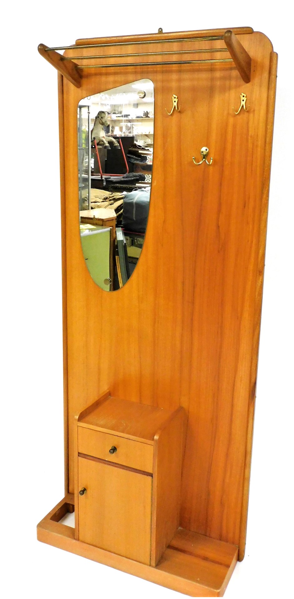 A mid century Entryway teak hall stand, with metal rails, shaped mirror and fixed pegs, above cupboa