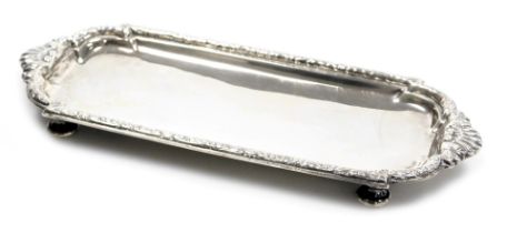 A George V Britannia silver wick trimmers or pen tray, of cast shaped rectangular form with shell ha