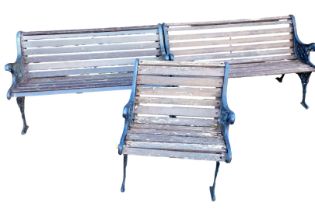 A pair of wooden slatted two seater benches, with black cast iron ends, 126cm wide, together with a