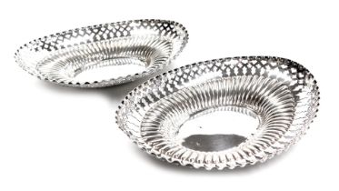 A pair of Edwardian silver oval sweetmeat dishes, of pierced and semi fluted form, London 1904, 5.38