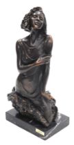 A late 20thC Andre Paor bronze sculpture of a young woman, modelled emerging from a rock raised on a