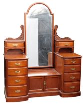 A Victorian mahogany dressing chest, the central domed mirror inset bevelled glass, flanked by a fol