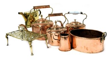 A group of 19thC and later copper and brass ware, including three copper kettles, two brass range st