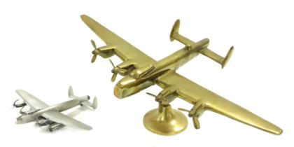 A brass desk stand, modelled as a WWII Avro Lancaster, raised on a circular base, 35.5cm wide, toget