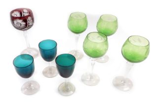 A Bohemian ruby long stemmed wine glass, four green, long stemmed wine glasses, engraved with flower