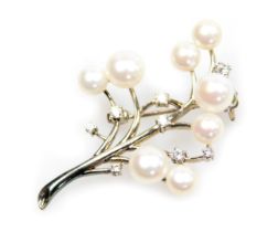 A modern white metal and cultured pearl spray brooch, interspersed with white stones, marked 925.