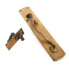 A Victorian art nouveau brass shop door handle, with latch, 34.5cm high, together with a brass door