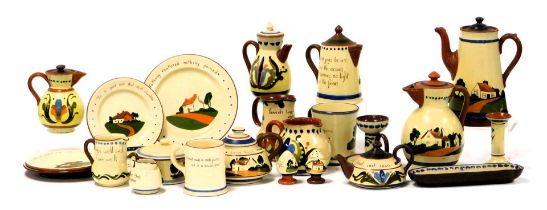 A group of early 20thC Devon Motto Ware pottery, including a coffee pot, coffee jugs, chamber stick,
