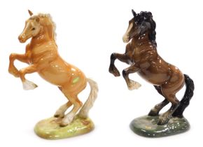 Two Beswick pottery figures of rearing horses, model number 1015, one Palomino, the other brown glos