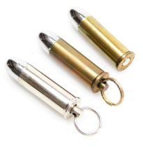 A forty four magnum silver bullet cigar cutter, and two further forty four magnum cigar cutters, wit