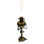 An early 20thC Jugenstil style brass oil lamp, presentation engraved, with a glass chimney, 71cm hig