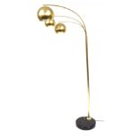 A brushed polished brass three branch uplighter, raised on a circular black base, 190cm high.