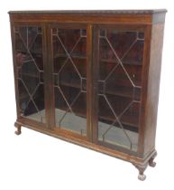 A late Victorian mahogany bookcase, with three astragal glazed doors enclosing three shelves, raised