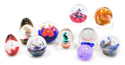 A group of glass paperweights, including a Caithness Moon Crystal weight, a Myriad weight and a Selk
