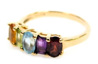 A 9ct gold and five stone rainbow ring, set with a garnet, amethyst, aquamarine, citrine and topaz,