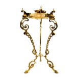 A 20thC brass plant stand, raised on three dolphin capped scrolling supports, 60cm high.