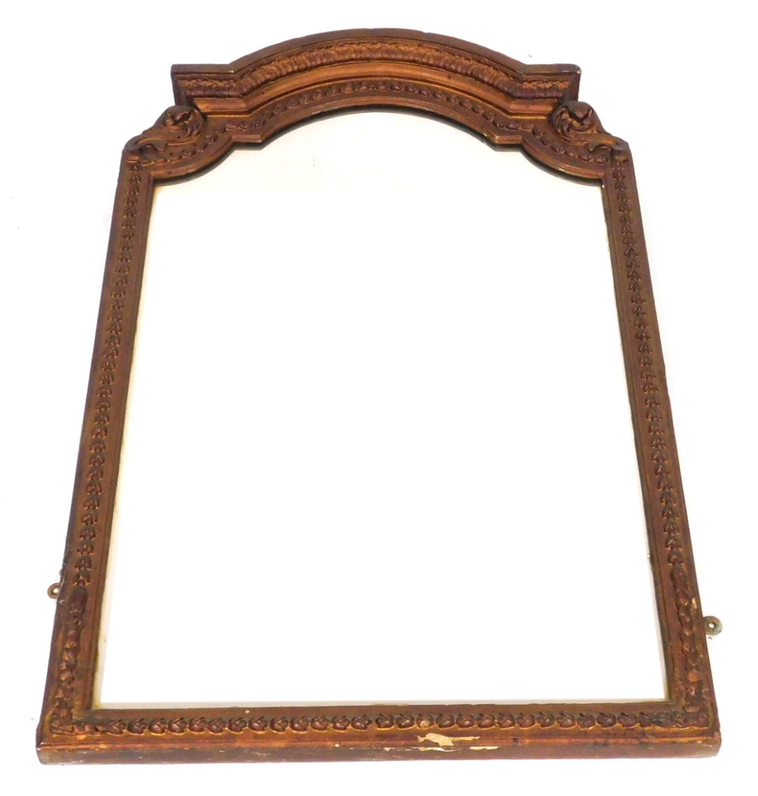 A late 19thC gilt wood wall mirror, with a domed top, carved with scrolling leaves and repeating har