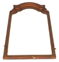 A late 19thC gilt wood wall mirror, with a domed top, carved with scrolling leaves and repeating har