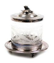 A late 19thC cut glass biscuit barrel, with plated mount and hinged lid, with engraved decoration, o