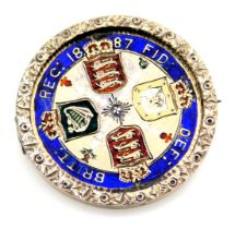 A Queen Victoria 1887 double florin enamelled brooch, in a reversible pivoting circular mount with p