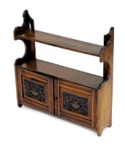 A Victorian mahogany wall mounted cupboard bookcase, with two shelves over a pair of carved panelled