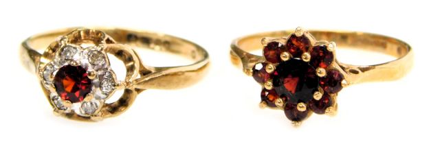 Two 9ct gold flowerhead cluster rings, one set with garnets, the other with a small ruby within a bo