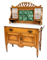 A Victorian marble topped satin walnut washstand, with a carved crest rail, above a six green floral