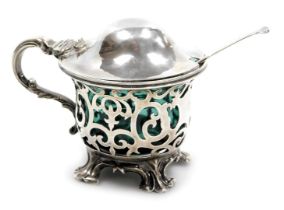 A Victorian silver mustard pot, with turquoise blue liner and pierced foliate decoration, raised on