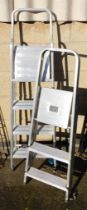Two aluminum step ladders.
