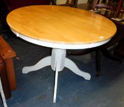 A modern kitchen circular table, raised on four cabriole legs.
