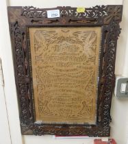 A wooden framed wood cuttting of The Lord's Prayer.