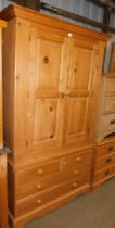 A pine double door wardrobe, cornice over double doors, above series of two short over two long draw