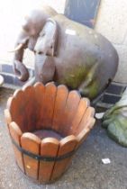 Garden ornament in the form of a standing elephant, and a wooden planter.