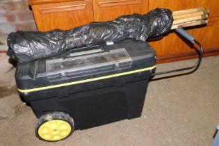 A large plastic tool box and a quantity of drain rods.