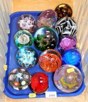 Thirteen glass paperweights, variously decorated. (13)