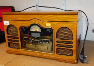 A radio and compact disc player, in the style of a vintage radio.