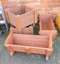 Wooden garden planters, two of square form and two of trough form. (4)