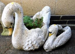 Two garden planters in the form of swans.