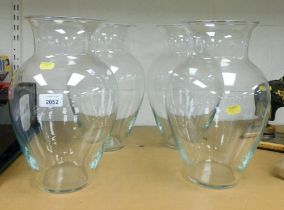 Four large glass vases.