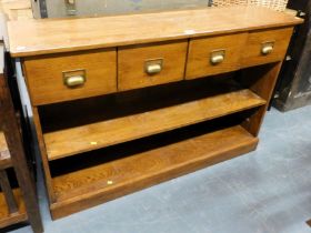 A Laura Ashley oak unit of four drawers with two shelves below, raised on a plinth base.