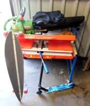 A garden leaf blower, scooter, garden table in case and a skate board.