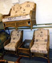 A wicker conservatory suite, comprising of sofa, two single chairs and a matching coffee table.