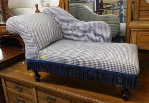 A Victorian style mahogany miniature chaise longue, upholstered in blue button back gingham fabric,