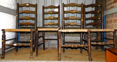 A set of four ladder back rush seated dining chairs.