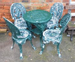 A Coalbrookdale style green metal garden table and four chairs.