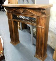 A fireplace surround, with carved leaf finials and metal cross section, on two plinth columns, 125cm