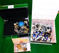 A jewellery box containing costume jewellery, including small brooches, together with a musical box