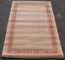 A machine made rug, 120cm x 170cm.